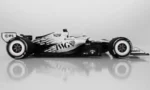 White Formula 1 race car shown in side profile on a reflective surface.