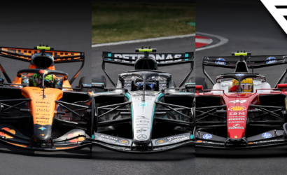 Three Formula 1 cars lined up on a race track from a front-on angle: orange McLaren on the left, silver Mercedes in the middle, and red Ferrari on the right with prominent rear wings and sponsor logos.
