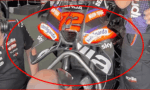 Aprilia MotoGP race bike with number 72 and sponsor stickers (Sterilgarda, Sky) in a pit area.