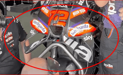 Aprilia MotoGP race bike with number 72 and sponsor stickers (Sterilgarda, Sky) in a pit area.