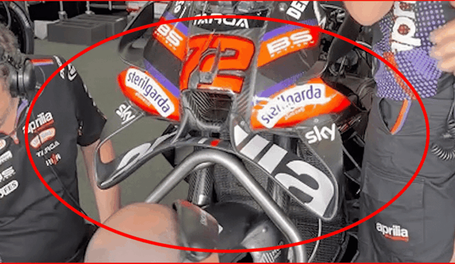Aprilia MotoGP race bike with number 72 and sponsor stickers (Sterilgarda, Sky) in a pit area.