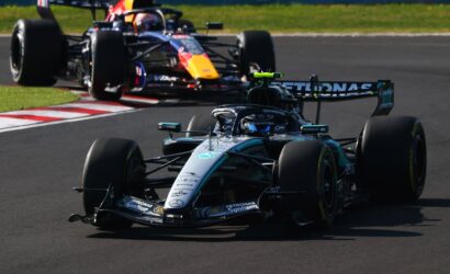 Mercedes AMG Petronas F1 car leads a corner on the race track, with a Red Bull car close behind