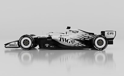 Side view of a black-and-white Formula 1 race car on a reflective surface with sponsor logos visible along the bodywork.