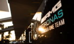 Mercedes‑Benz AMG Petronas Formula One Team logo on a glossy black surface with sun glare
