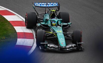Green Formula 1 car seen from above turning into a curbed corner on a dark race track, sponsor logos visible on the nose and wings.