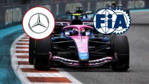 Pink Formula 1 race car speeding along a circuit with Mercedes and FIA logos overlaid above it