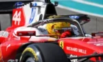 Red Formula 1 race car speeding on track, driver in a yellow helmet with sponsor logos visible across the car.3a8️👨‍🚀