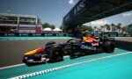 Formula 1 car on a race track near the pit lane with MSC Cruises banners along the barrier.