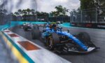 Formula 1 cars race around a tight Miami hairpin, blue track with turquoise runoff and barrier walls, palm trees in the background.