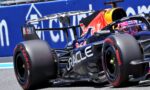 Race car close-up: Red Bull Racing Formula 1 car with Oracle branding and prominent rear wing in motion on track