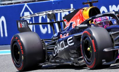 Race car close-up: Red Bull Racing Formula 1 car with Oracle branding and prominent rear wing in motion on track