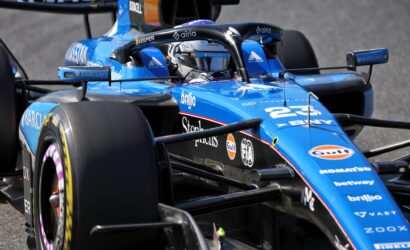 Blue Formula 1 race car close-up of cockpit and front wing, with sponsor logos visible (Barclays, Gulf).