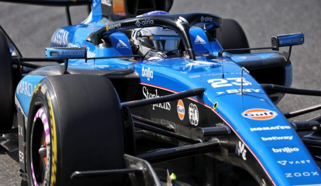 Blue Formula 1 race car close-up of cockpit and front wing, with sponsor logos visible (Barclays, Gulf).