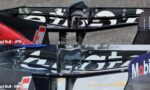 Close-up of a carbon-fiber race car wing with Red Bull branding and the caption 'Red Bull - JPN' overlayed