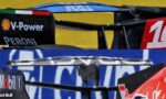 Close-up of race car rear wings with sponsor logos including V-Power, Peroni, Ferrari, and Red Bull.