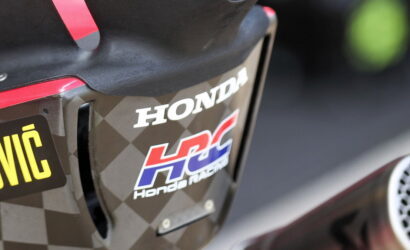 Close-up of a Honda racing motorcycle rear with HRC logo on a checkered body