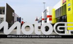 Large white MotoGP sign in a race paddock with 'Estrella Galicia 0,0 Grand Prix of Spain 2026' on the base.