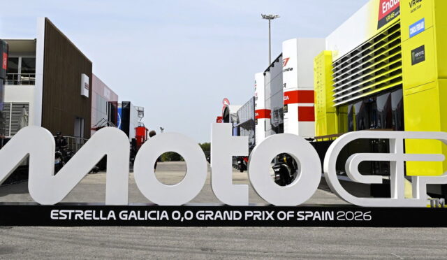 Large white MotoGP sign in a race paddock with 'Estrella Galicia 0,0 Grand Prix of Spain 2026' on the base.