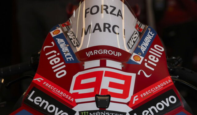 Red racing motorcycle front with number 99 and sponsor logos (Lenovo, Monster Energy, Shell, Frecciarossa) and 'FORZA MARC' on a white windshield.
