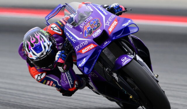 MotoGP rider leaning into a corner on a purple Yamaha race bike with number 43