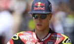 Rider wearing a Red Bull cap and reflective sunglasses in a red and black racing suit. liq Boa border not included