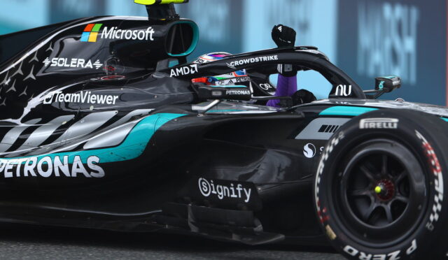Mercedes‑AMG Formula 1 car on track with driver in cockpit, featuring sponsor logos like Microsoft, Petronas, TeamViewer, AMD and CrowdStrike.