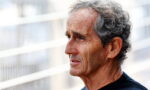 Profile of an older man with gray hair outdoors, wearing a black shirt
