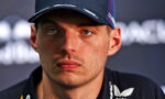 Close-up of a male athlete wearing a dark cap, looking off-camera with a serious expression.