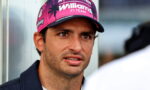 Man wearing a pink Williams F1 Team cap looking slightly to the right during an interview.