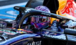 Close-up of a Formula 1 cockpit with a purple helmet and sponsor logos (DAMAC, Wells Fargo).