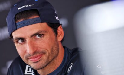 Close-up of a man wearing a navy Kraken cap, only the left side of his face visible as he looks to the side