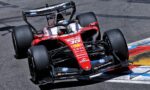 Red Formula 1 race car on a track, visible front wing, slick tires, and sponsor logos (HP, Shell, Bing) on the red chassis as it navigates blue-and-red curbs.
