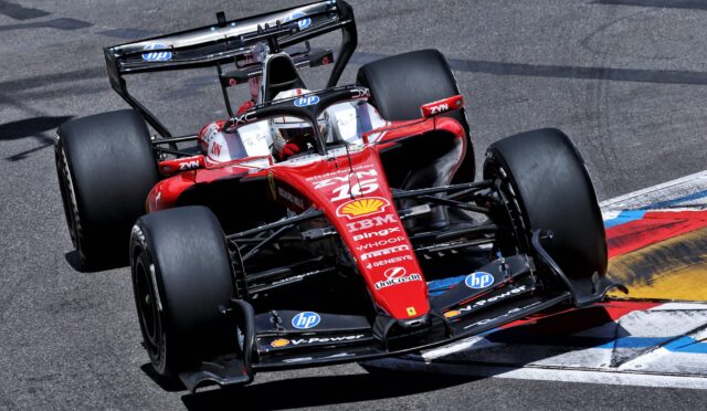 Red Formula 1 race car on a track, visible front wing, slick tires, and sponsor logos (HP, Shell, Bing) on the red chassis as it navigates blue-and-red curbs.