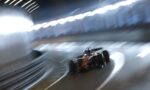 Red Formula 1 car speeding through a dim tunnel, captured with motion blur and streaks of light along the walls through a curved track.