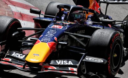 Close-up of a Red Bull Racing Formula 1 car on track, showing the colorful nose, sponsor decals, and front wing details.