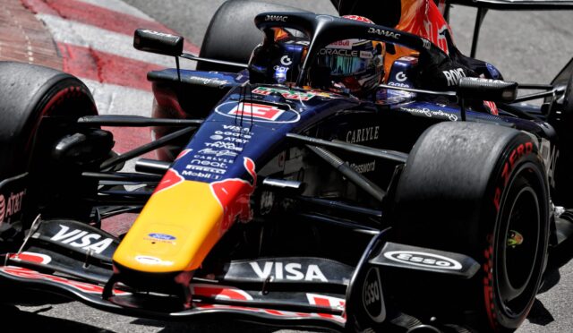 Close-up of a Red Bull Racing Formula 1 car on track, showing the colorful nose, sponsor decals, and front wing details.