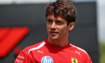 Portrait of a young man in a red athletic shirt with HP logo and Ferrari crest, outdoors in daylight.