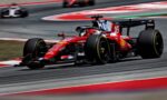 Ferrari Formula 1 car, number 16, in red livery, speeding around a curve on a race track with motion blur behind it.
