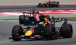 Red Bull Formula 1 car leads a high-speed race on a track, with other cars blurred in the background to show motion blur.