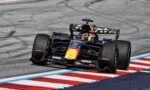 Race-ready Formula 1 car on a curving track, Red Bull livery, front wing down and tires smoking the tire marks in the asphalt background
