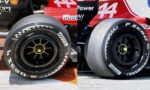 Side-by-side comparison of Ferrari race wheels: left shows old tire with white lettering, right shows newer tire with updated branding on a red car