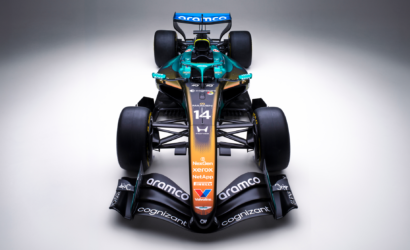 Front view of a teal-and-orange Formula 1 car with large rear wing and sponsor logos visible, facing the camera.