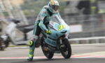 Motorcycle racer in teal livery leans into a track turn on a racing bike number 31 with Leopard branding.