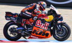 MotoGP rider on a Red Bull KTM bike leaning into a turn on a racetrack