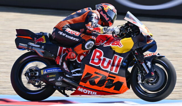 MotoGP rider on a Red Bull KTM bike leaning into a turn on a racetrack