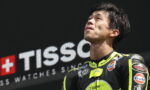 Motorcycle racer in neon yellow and black suit gazing upward on a podium with a TISSOT banner in the background](https://)