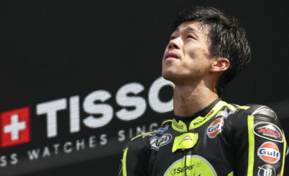Motorcycle racer in neon yellow and black suit gazing upward on a podium with a TISSOT banner in the background](https://)