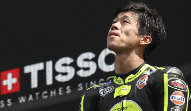 Motorcycle racer in neon yellow and black suit gazing upward on a podium with a TISSOT banner in the background](https://)