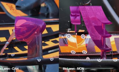Close-up of purple cockpit component and wing on an orange McLaren Formula 1 car.