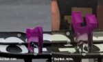 Close-up of a car instrument panel with two purple shift paddles and event labels ‘Red Bull - CAN’ and ‘Red Bull - MON’ at the bottom.